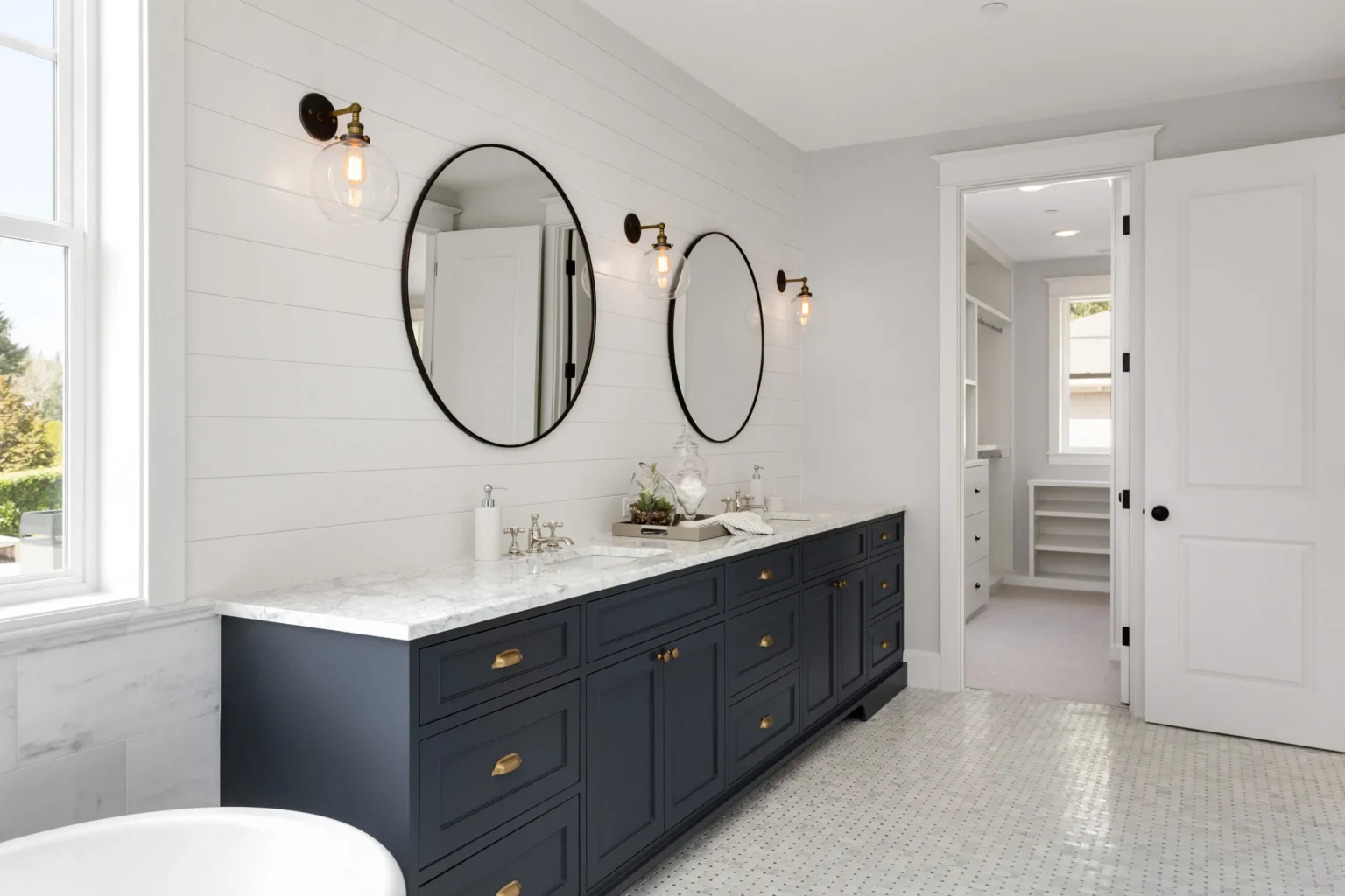 Luxury bathroom remodel with dual vanity and round mirrors